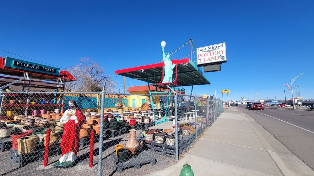 Exterior of San Miguel Pottery Land showing colorful pottery and outdoor displays in Socorro, New Mexico.